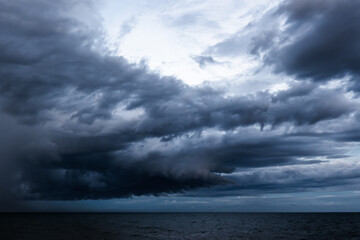 Dramatic dark cloudy sky over sea, natural photo background