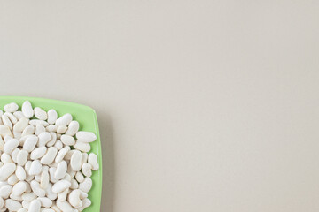 White beans in food trays on concrete background