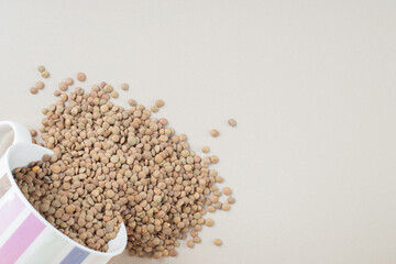 Green lentil beans isolated on concrete background