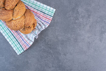 Loaf of Strucia bread on a towel on marble background