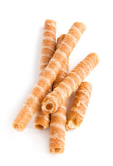 Sweet waffle tubules with a vanilla cream on the white background