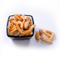 Nuts and crackers for beer in a glass bowl isolated on white background.