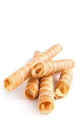Sweet waffle tubules with a vanilla cream on the white background