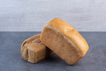 Two bread batons stacked on marble background