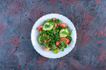 Shepherd's salad mixed with parsley leaves on dark colored background