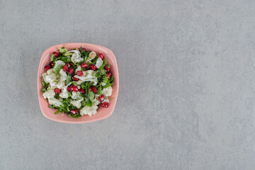 Obraz na płótnie Canvas Cauliflower salad with herbs and pomegranate seeds