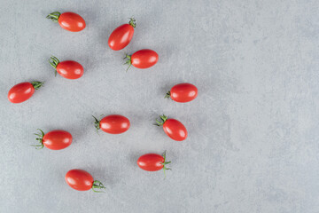 Top view of red chili tomatoes isolated on concrete background