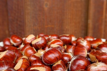 The rich color of edible chestnuts combined with a wooden wall creates a feeling of homely warmth...