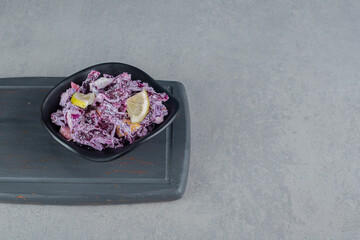 Purple cabbage and onion salad in a ceramic cup