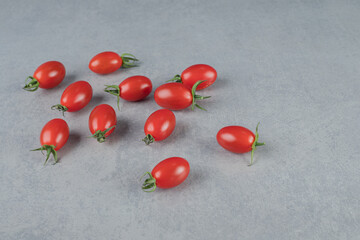 Red cherry tomatoes isolated on grey background