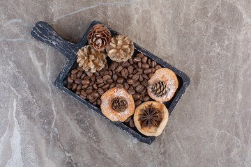 Delectable cookies. anise, coffee beans and pine cones on marble background