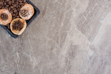Cookies. anise, coffee beans and pine cones on marble background
