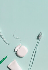 Dental care concept frame with toothbrush, irrigator, tooth floss and toothpaste on the blue background. Copy space