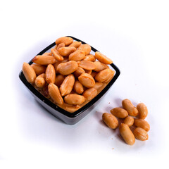 pile of spiced peanuts isolated close up on white background 
