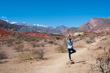 Fototapeta premium Woman in yoga potition in Quebrada las Conchas, Cafayate. 