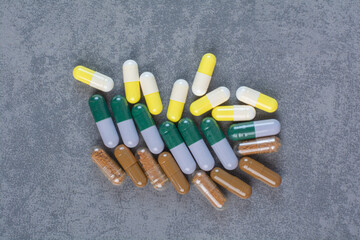 Assorted pharmaceutical capsules on marble surface