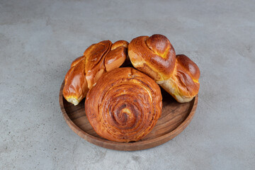 Stack of sweet buns, on a small tray on marble background