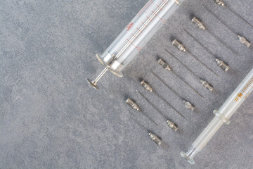 Huge and normal size syringes on marble background