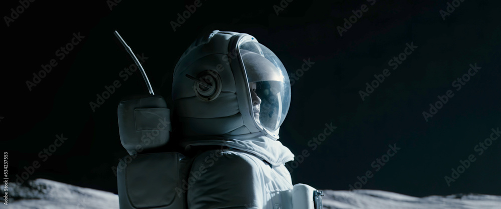Wall mural portrait of asian lunar astronaut opens his visor while exploring moon surface