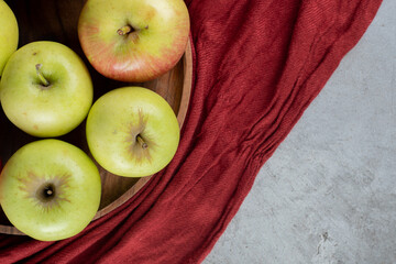 Green apples on a tray on marble background