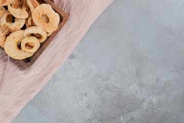 Small tray of fried apple rind on textile background