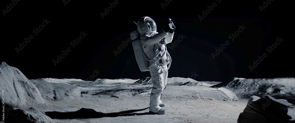 Wall mural astronaut searching for cellular or wi-fi signal while walking on moon surface