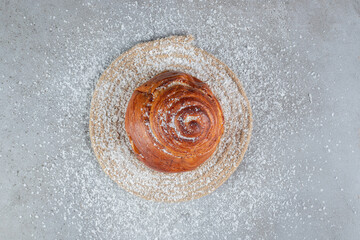 Sweet bun on a coconut powder coated trivet on marble background