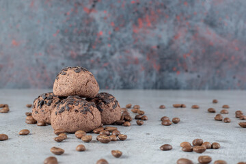 Chocolate chip cookies and scattered coffee beans on marble background