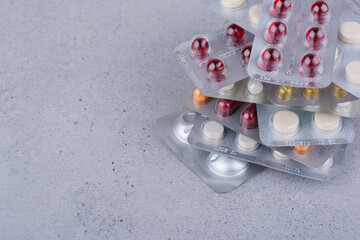 Fototapeta na wymiar Stack of medical drugs on marble background