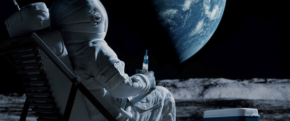 Back view of lunar astronaut having a beer while resting in a beach chair on Moon surface, saluting to Earth © supamotion