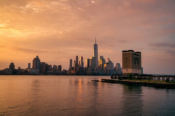 Fototapeta na wymiar Panoramic New York City skyline at sunrise. Manhattan office buildings/skyscrapers in the morning. Panoramic shot of New York City