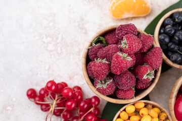 A wooden bowls full of delicious berries