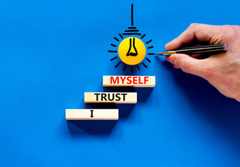 I trust myself symbol. Concept words I trust myself on wooden blocks. Businessman hand. Beautiful...