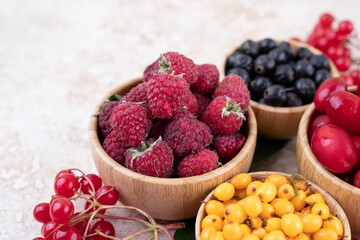 A wooden bowls full of delicious berries