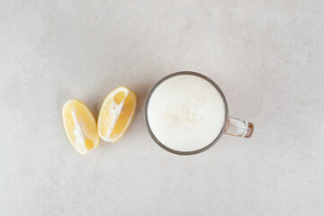 Obraz na płótnie Canvas Glass of beer with lemon slices on stone surface