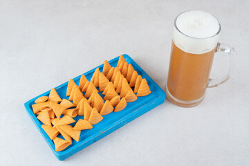 Chips plate and glass of beer on stone surface