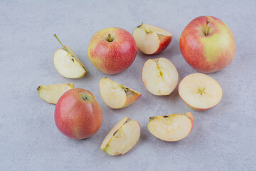 Three whole apple with slices on white background