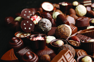 Delicious chocolate candies on a wood background, close-up