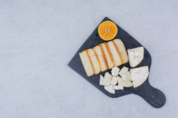 Sliced white bread with slice of orange on cutting board