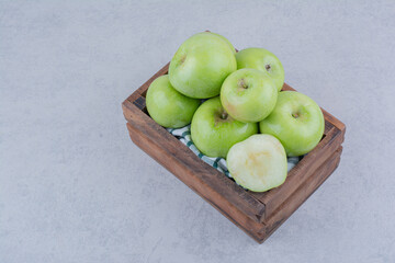 Green tasty apples in wooden basket
