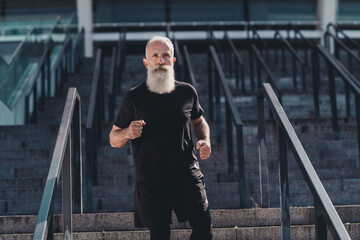 Photo of aged sporty man run wear black t-shirt shorts outside in town