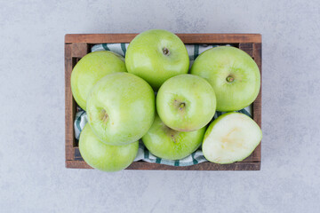 Green tasty apples in wooden basket
