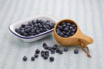 Fototapeta na wymiar Kuksa(Finnish wooden mug) and fresh blueberries