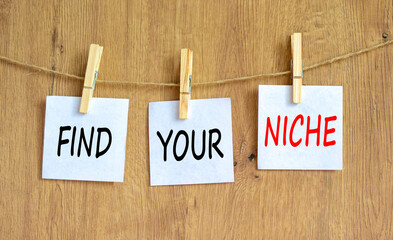 Find your niche symbol. Concept words Find your niche on white papers on wooden clothespins....