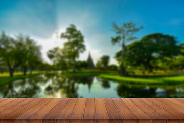 Wooden table and blur of beauty on sunset day and Thai temple.