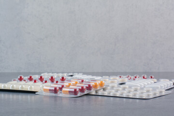 Fototapeta na wymiar Assorted packs of drugs on marble surface