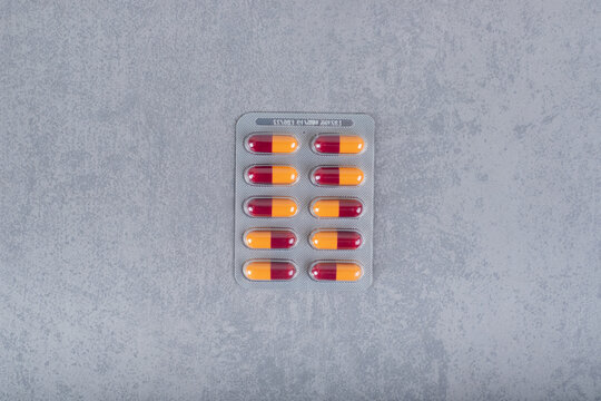 Blister of medicine pills on a gray background