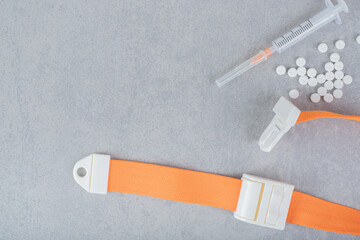 Empty syringe with white pill on a gray background