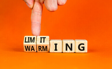 Limiting global warming symbol. Concept words Limiting and Warming on wooden cubes. Businessman...