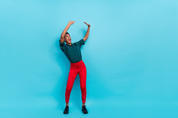 Full length body size view of attractive thin cheerful woman dancing holding copy space isolated over bright blue color background